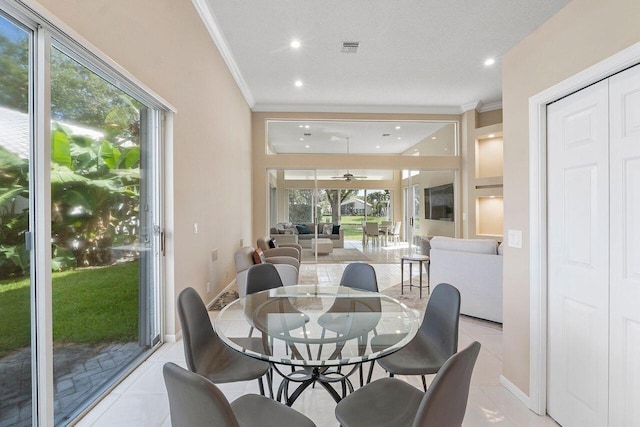 tiled dining area featuring a textured ceiling and ornamental molding