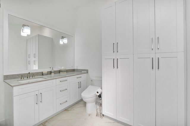 bathroom with vanity and toilet