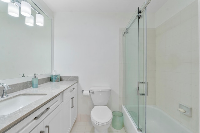 full bathroom with tile patterned flooring, vanity, toilet, and bath / shower combo with glass door