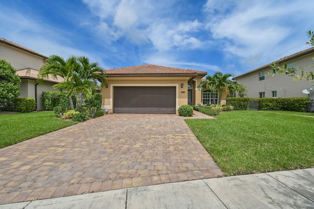 mediterranean / spanish home featuring a garage and a front lawn