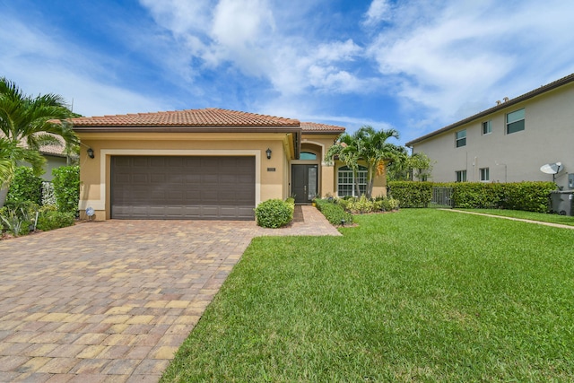 mediterranean / spanish-style house with a front lawn and a garage