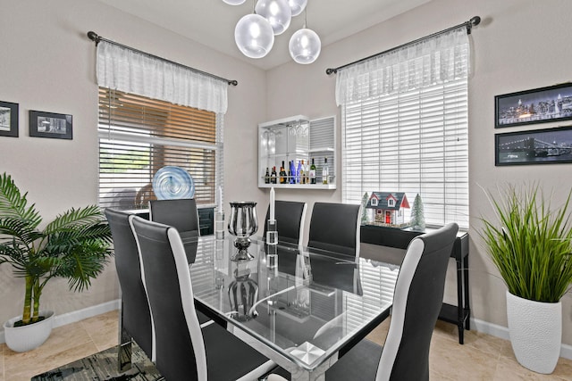 tiled dining area with a chandelier