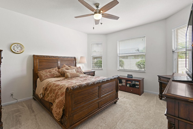 bedroom with light carpet and ceiling fan