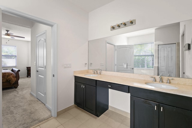 bathroom with a wealth of natural light, vanity, ceiling fan, and tile patterned flooring