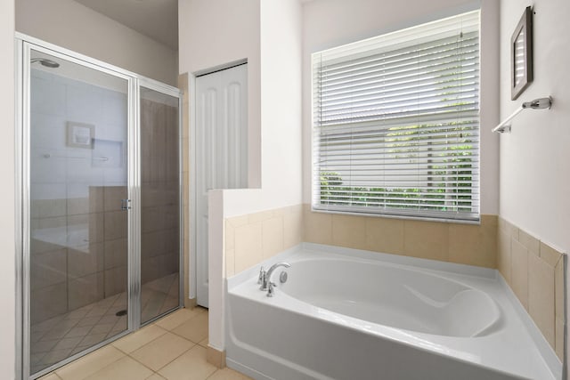 bathroom with separate shower and tub and tile patterned floors