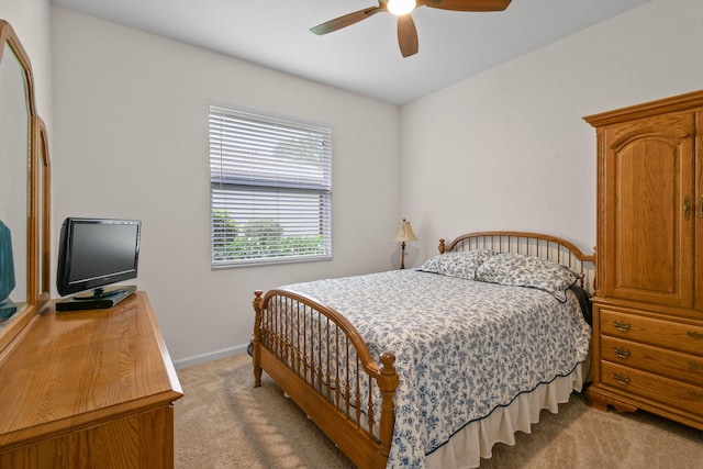 bedroom with ceiling fan and light carpet