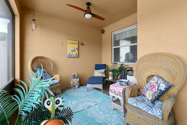 interior space featuring outdoor lounge area and ceiling fan