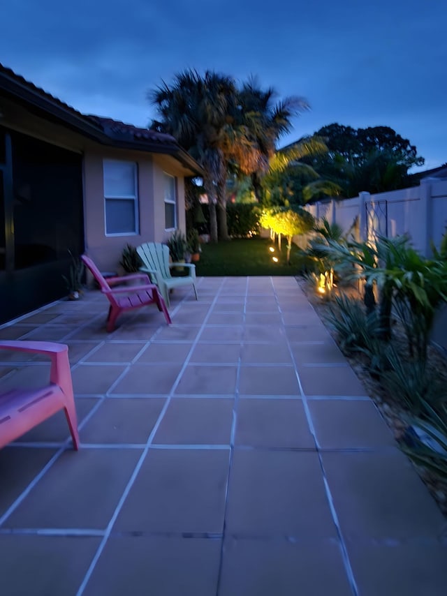 pool at dusk with a patio