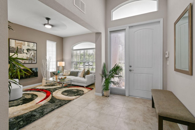 tiled entryway with ceiling fan