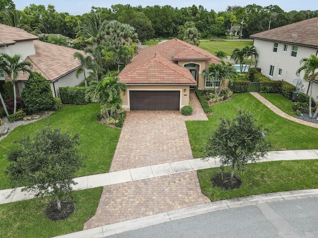 view of front of property with a garage and a front yard