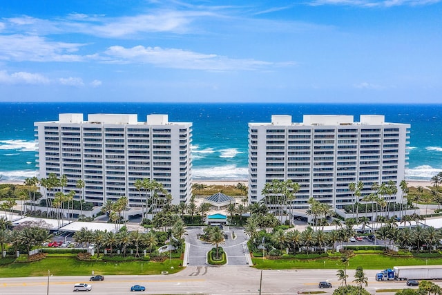 birds eye view of property with a water view and a view of the beach