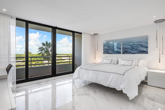 bedroom featuring a water view, expansive windows, and access to outside