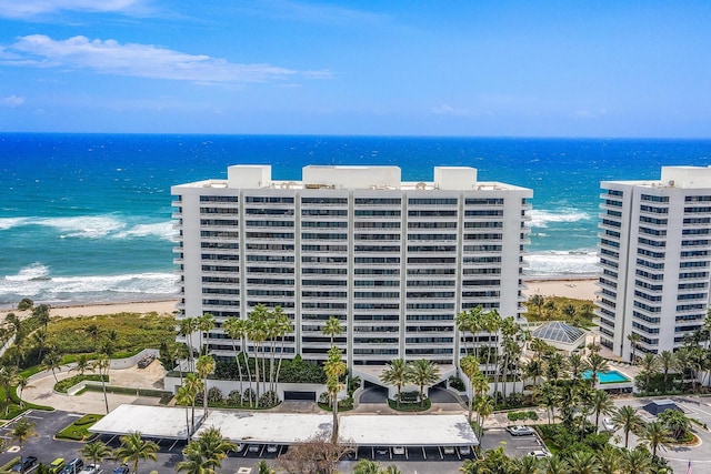 view of building exterior featuring a view of the beach and a water view