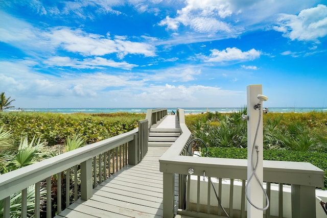 view of property's community featuring a water view and a view of the beach