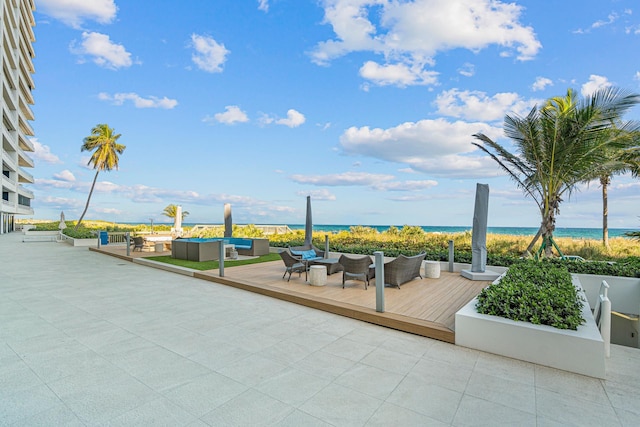 view of patio / terrace with an outdoor living space and a water view