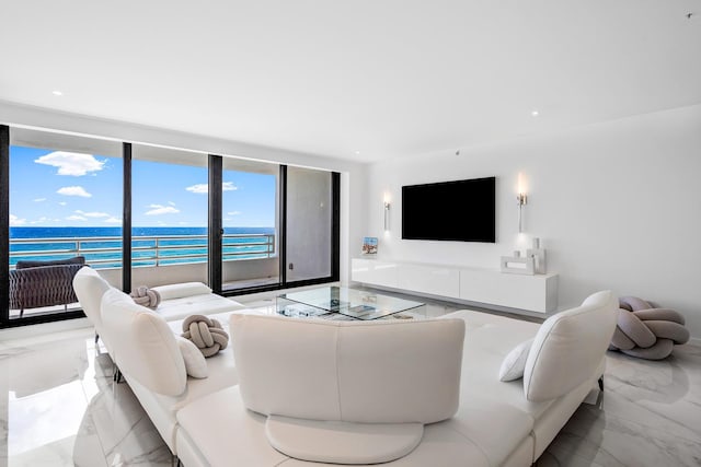 living room featuring expansive windows and a water view