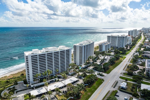 bird's eye view with a water view and a view of the beach