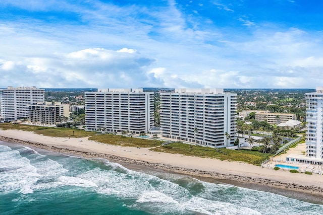 birds eye view of property featuring a water view and a beach view