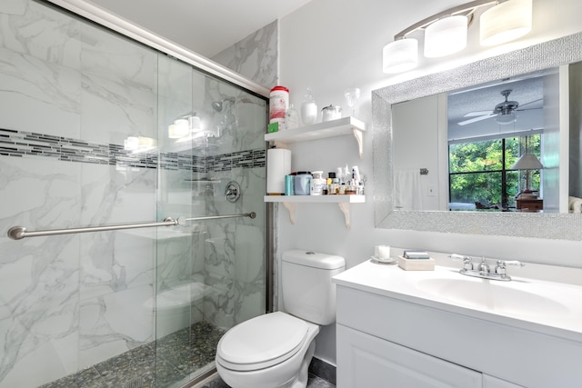 bathroom featuring an enclosed shower, ceiling fan, toilet, and vanity