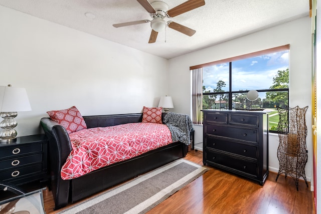 bedroom featuring a textured ceiling, ceiling fan, and hardwood / wood-style floors