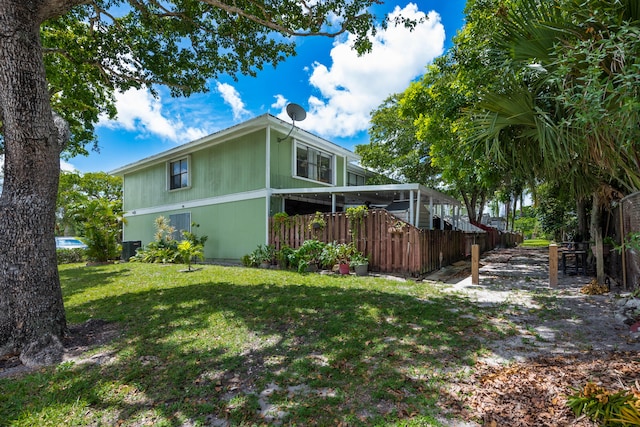 view of side of home with a yard and cooling unit