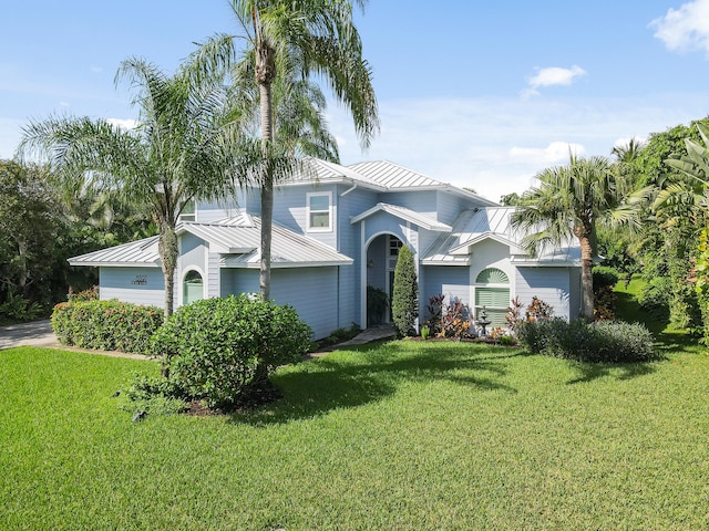 view of front of property featuring a garage and a front yard