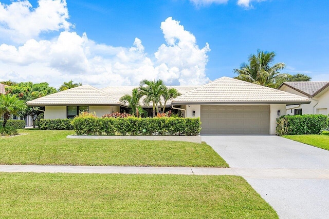 ranch-style house with a garage and a front yard