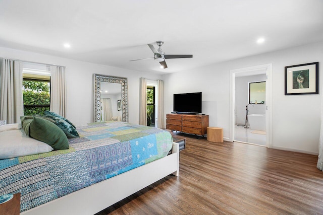 bedroom featuring ensuite bath, ceiling fan, and dark hardwood / wood-style floors