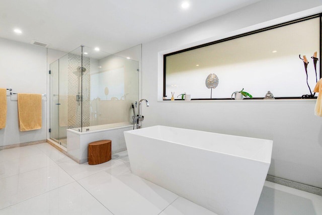 bathroom featuring tile patterned flooring and shower with separate bathtub