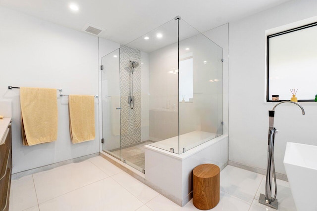 bathroom featuring vanity, plus walk in shower, and tile patterned flooring