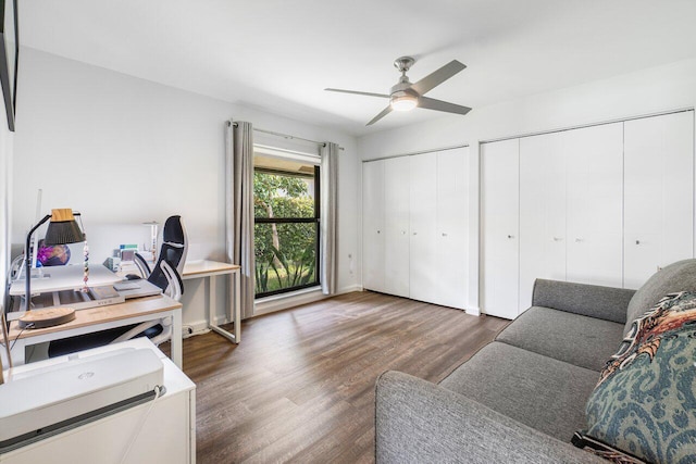 office area featuring dark wood-type flooring and ceiling fan