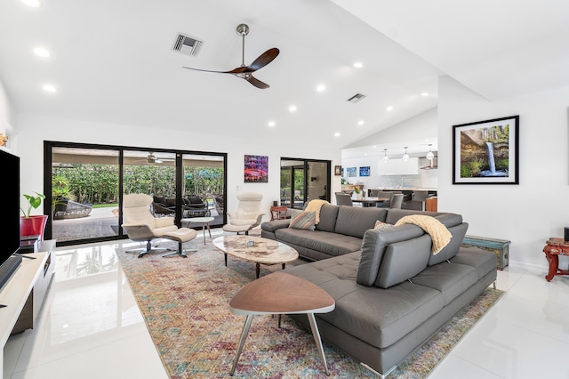 tiled living room featuring ceiling fan and vaulted ceiling