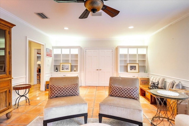 living area featuring built in shelves, visible vents, light tile patterned floors, and ornamental molding