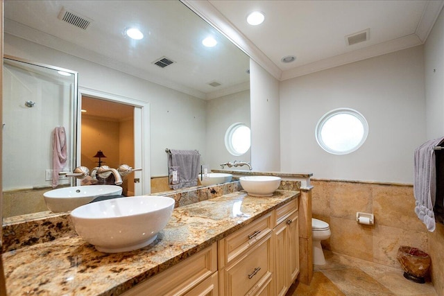 full bath featuring visible vents, tile walls, and a sink