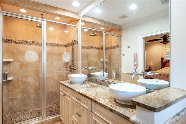 bathroom with a sink, visible vents, a stall shower, and double vanity