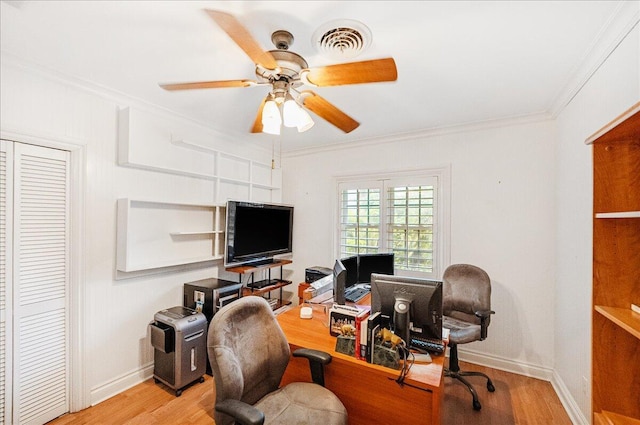 home office featuring visible vents, a ceiling fan, wood finished floors, and crown molding