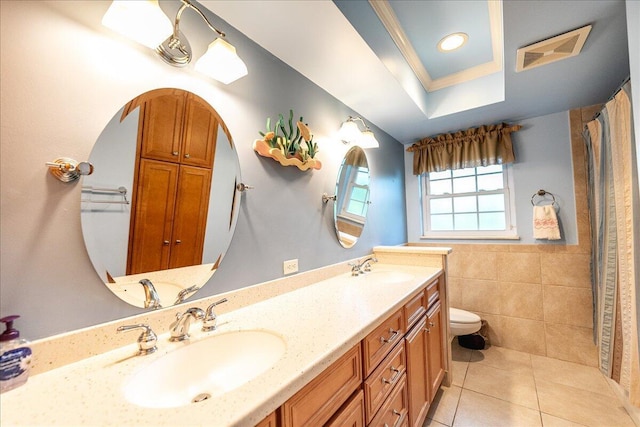 full bath with tile walls, toilet, visible vents, and a sink