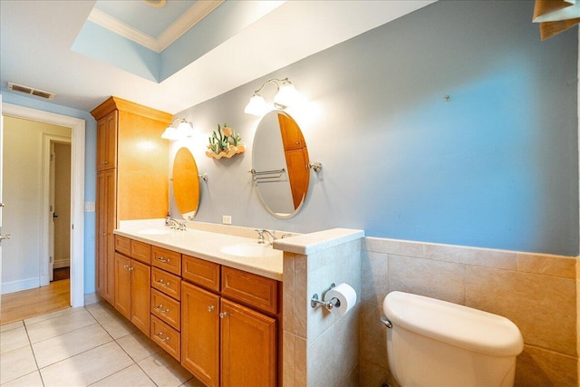 bathroom with tile patterned floors, visible vents, toilet, a sink, and double vanity