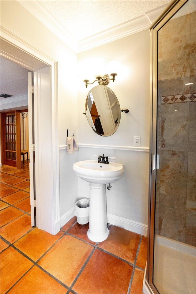 full bath with visible vents, a shower stall, baseboards, and ornamental molding