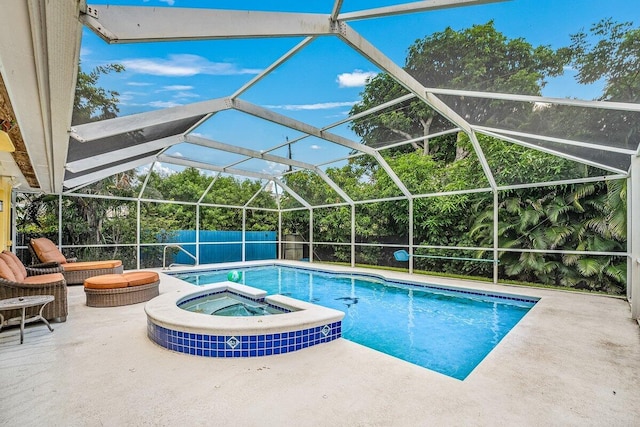 view of swimming pool with glass enclosure, a patio, a fenced backyard, and a pool with connected hot tub