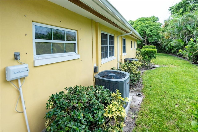 exterior space with stucco siding and central AC