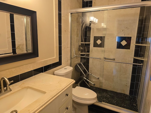 bathroom with vanity, walk in shower, tile walls, toilet, and decorative backsplash