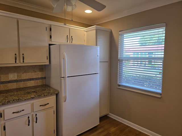 kitchen featuring white cabinetry, white fridge, dark stone counters, dark wood-type flooring, and ceiling fan