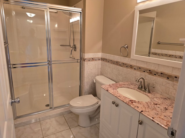 bathroom with an enclosed shower, toilet, tile walls, decorative backsplash, and vanity