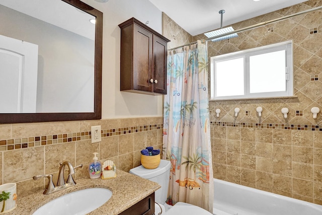 full bathroom featuring shower / bath combo with shower curtain, tile walls, toilet, and vanity