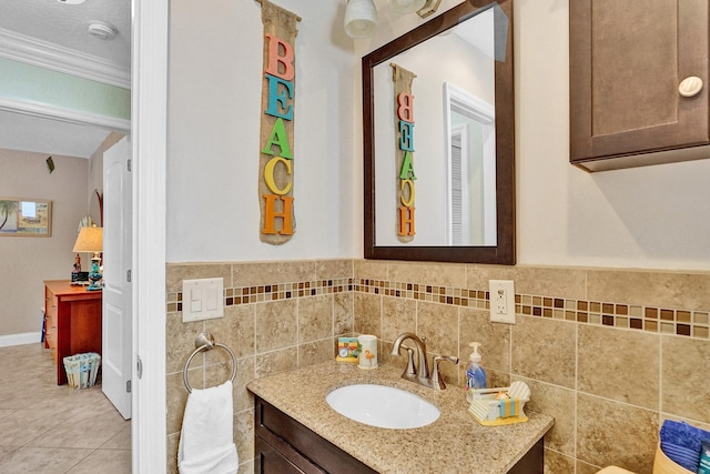 bathroom with crown molding, vanity, tile patterned floors, and a textured ceiling