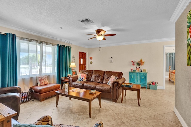 living room with ceiling fan, light tile patterned floors, crown molding, and a textured ceiling