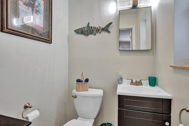 bathroom featuring toilet and vanity