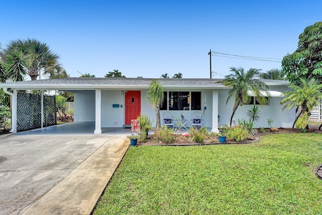 single story home with covered porch, a front yard, and a carport