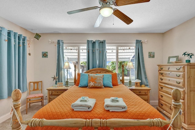 bedroom with ceiling fan and a textured ceiling